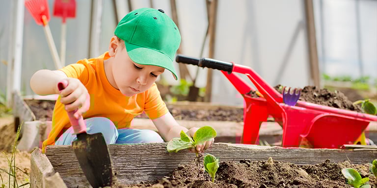 Child digging in garden
