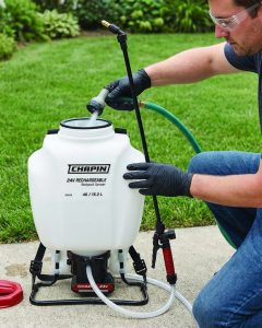 Filling a Chapin backpack sprayer with water with a garden hose nozzle