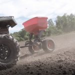 Chapin 8620B Tow Behind Spreader with Auto-Stop Dual Impeller in use in field