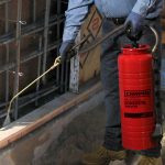 Chapin 1949 Industrial Concrete Sprayer spraying concrete foundation on construction site