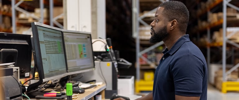 Man in manufacturing plant at computer