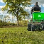 Chapin 89620B tow behind TurfpPro spreader in use in a field spreading fertilizer