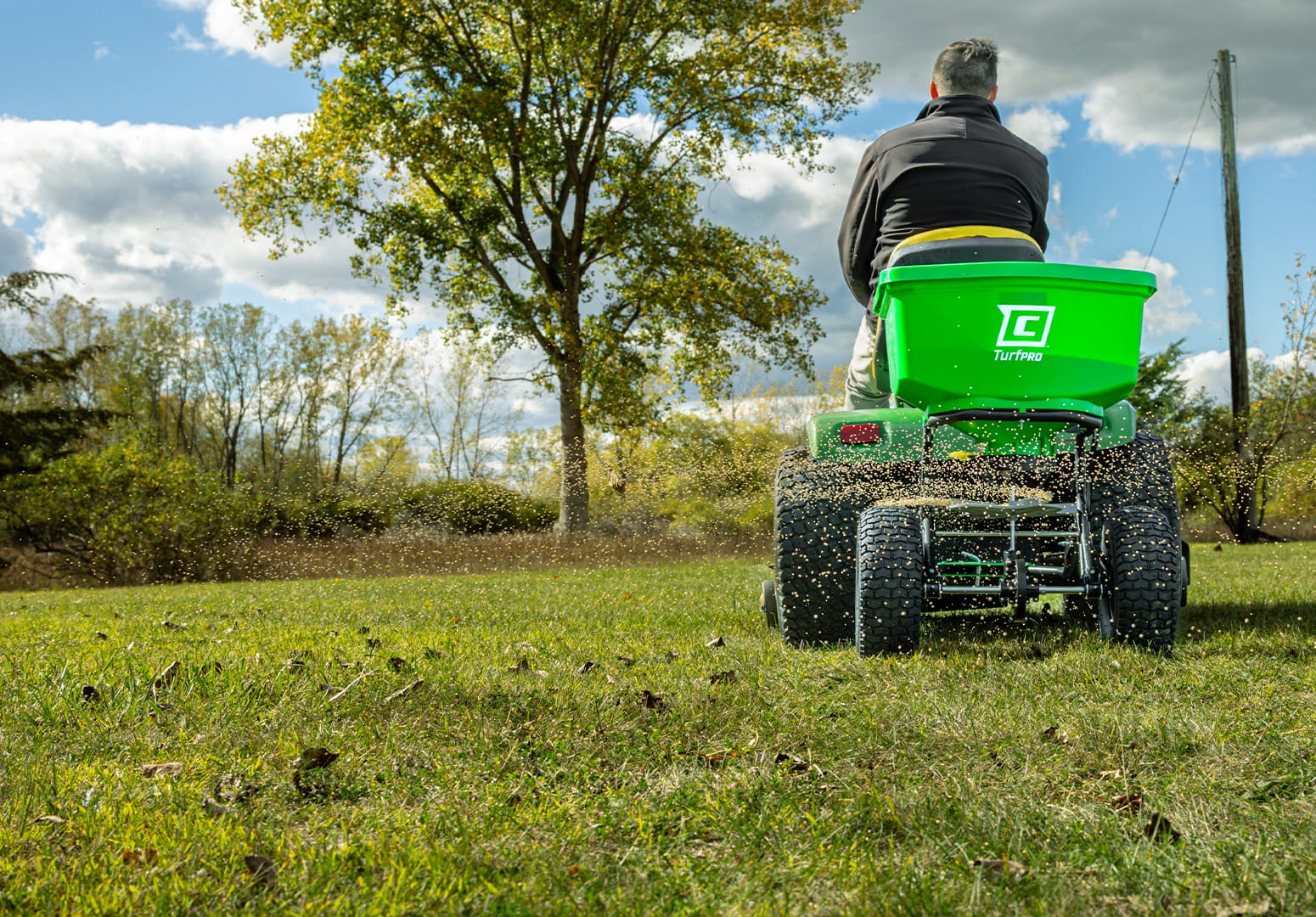 Chapin 89620B tow behind TurfpPro spreader in use in a field spreading fertilizer
