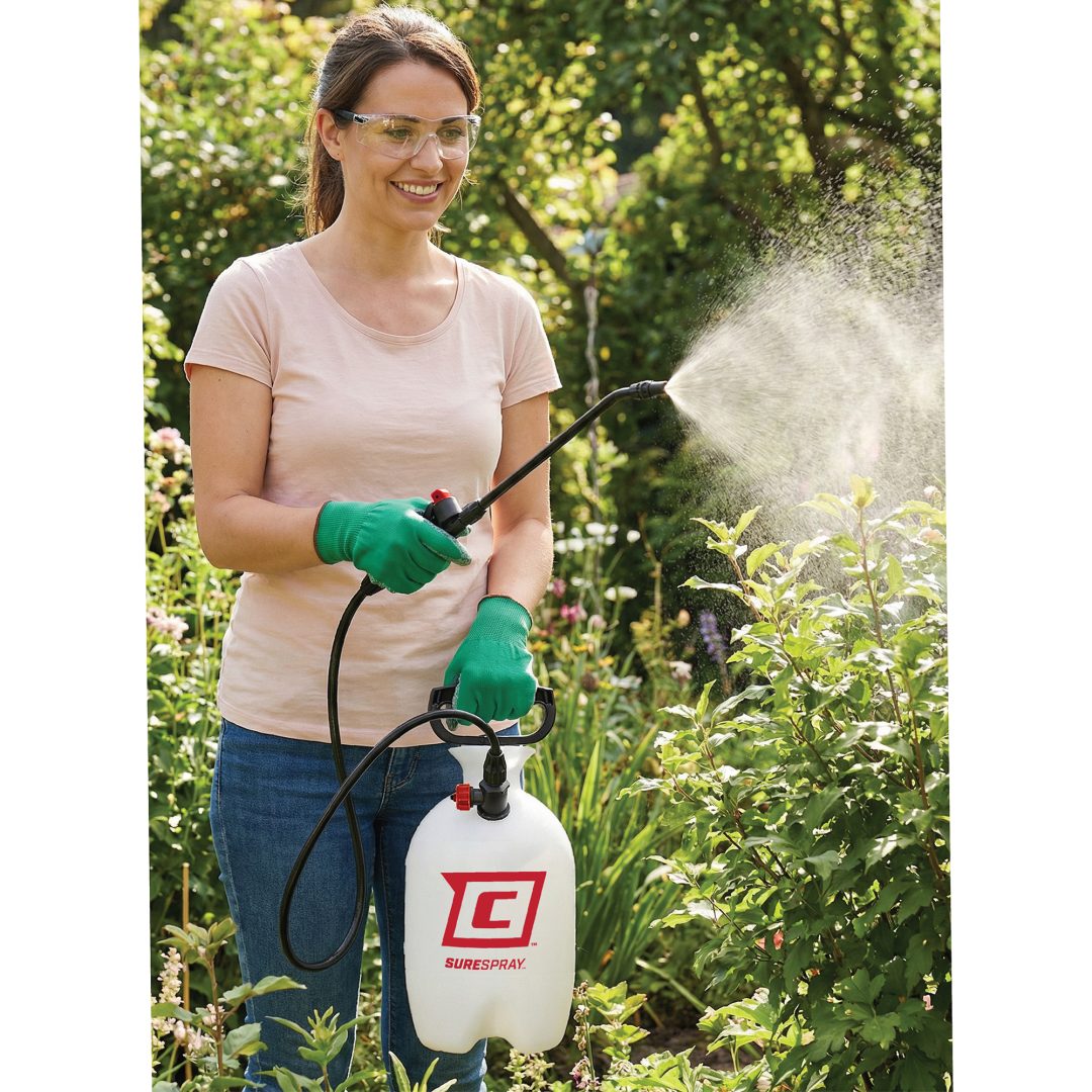 20000_-03 Woman spraying plants in a garden with a Chapin 20000 SureSpray garden sprayer