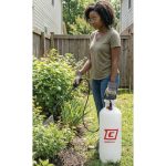 Woman spraying plants in a garden with a Chapin 20003 SureSpray garden sprayer